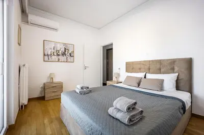 a bedroom with a large bed with towels on it at Traveler's Dream 3-Bedroom Renovated Penthouse in Athens