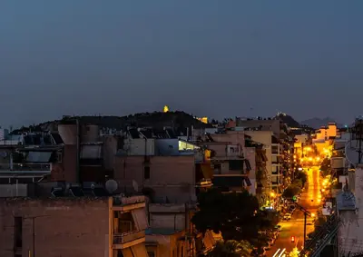 a view of a city at night with lights at Traveler's Dream 3-Bedroom Renovated Penthouse in Athens