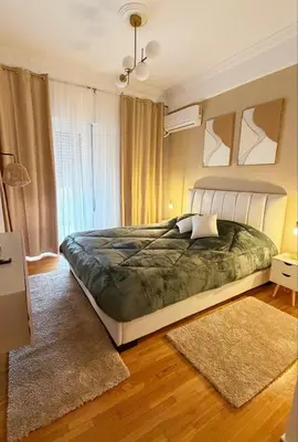 a bedroom with a large bed and a window at Dream House in Athens