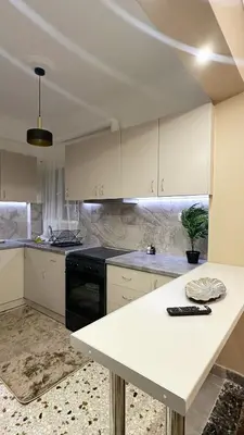 a kitchen with white cabinets and a white counter top at Dream House in Athens