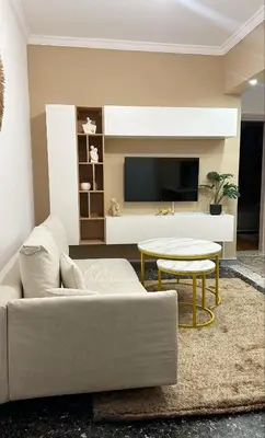 a living room with a couch and a table and a tv at Dream House in Athens