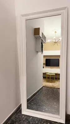 a mirror leaning against a wall with a living room at Dream House in Athens