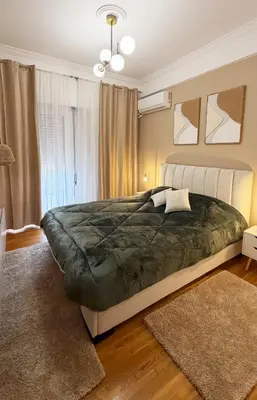 a bedroom with a large bed and a window at Dream House in Athens