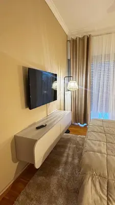 a bedroom with a tv on the wall and a bed at Dream House in Athens