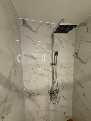 a shower in a bathroom with white marble at Byron cozy brand new apartment in Athens