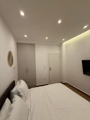 a bedroom with a large bed with white sheets at Byron cozy brand new apartment in Athens