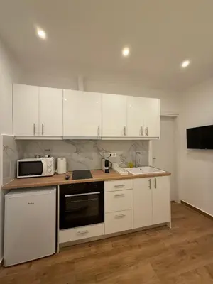 a kitchen with white cabinets and a microwave at Byron cozy brand new apartment in Athens