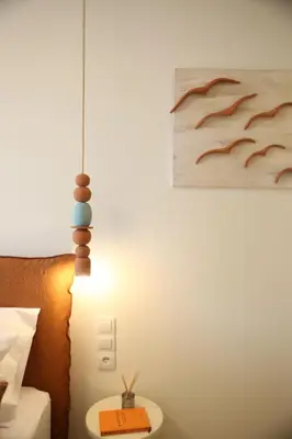 a lamp in a hotel room next to a bed at Terracotta Lofts in Athens