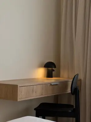 a desk with a lamp and a chair in a room at Terracotta Lofts in Athens