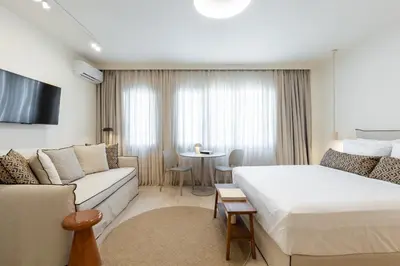 a hotel room with a bed and a couch at Terracotta Lofts in Athens