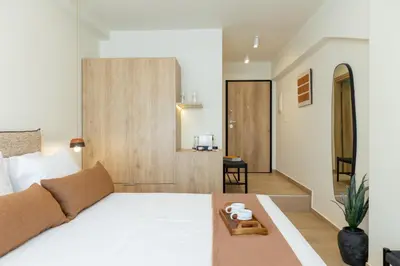 a bedroom with a white bed with a tray on it at Terracotta Lofts in Athens