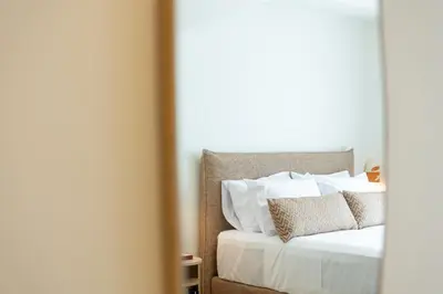 a bedroom with a bed with white sheets and pillows at Terracotta Lofts in Athens