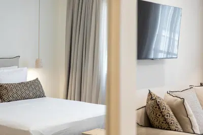 a room with a bed and a tv and a couch at Terracotta Lofts in Athens