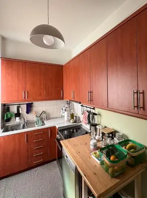 a kitchen with wooden cabinets and a wooden counter top at 2BDR Central, Bright & Cosy Flat by the Acropolis in Athens