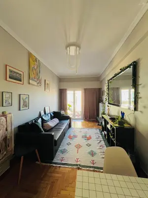 a living room with a couch and a table at 2BDR Central, Bright & Cosy Flat by the Acropolis in Athens