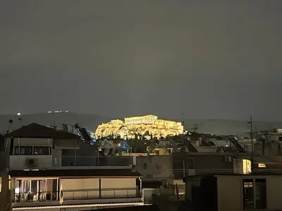 a view of a building lit up at night at 2BDR Central, Bright & Cosy Flat by the Acropolis in Athens