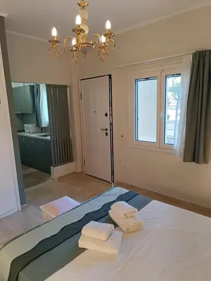 a bedroom with a bed with two towels on it at Athens Royal Suite in Athens