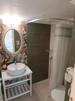 a bathroom with a sink and a mirror at Athens Royal Suite in Athens