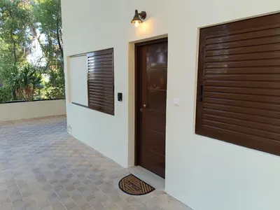 a house with two doors and a tile floor at Athens Royal Suite in Athens