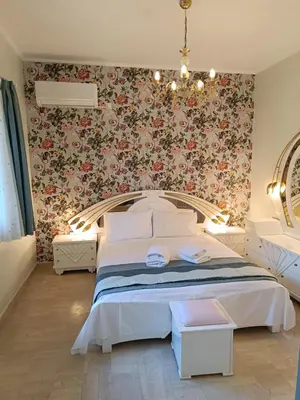 a bedroom with a bed with a floral wallpaper at Athens Royal Suite in Athens