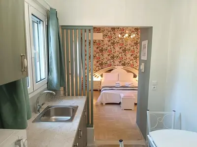 a kitchen with a sink and a bed in a room at Athens Royal Suite in Athens