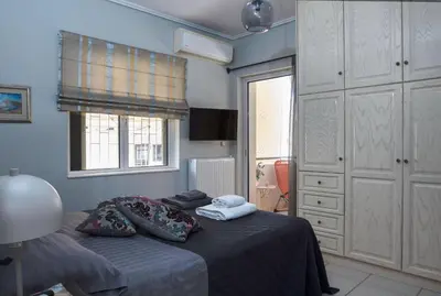 a bedroom with a bed with two pillows on it at Glyfada's Luxury Design Apartment with balcony in Athens