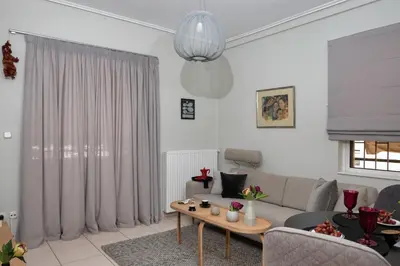 a living room with a couch and a table at Glyfada's Luxury Design Apartment with balcony in Athens