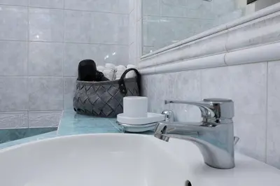 a bathroom with a sink and a faucet at Glyfada's Luxury Design Apartment with balcony in Athens
