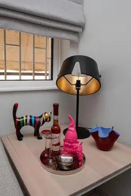 a table with a lamp and a toy dog on it at Glyfada's Luxury Design Apartment with balcony in Athens