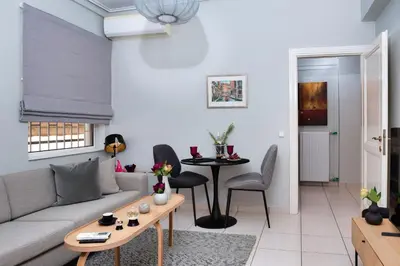 a living room with a couch and a table at Glyfada's Luxury Design Apartment with balcony in Athens