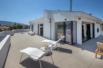 a white chair on the roof of a house at Luxury Loft Sauna HotTub Psyhiko in Athens