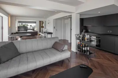 a living room with a couch and a dining room at Luxury Loft Sauna HotTub Psyhiko in Athens