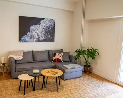 a living room with a couch and a table at Kypseli urban Oasis in Athens