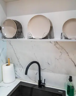 a kitchen counter with two plates and a sink at Kypseli urban Oasis in Athens