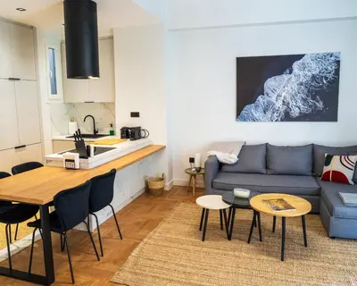 a living room with a couch and a table at Kypseli urban Oasis in Athens