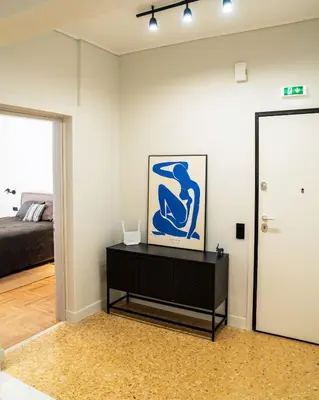 a living room with a black dresser and a mirror at Kypseli urban Oasis in Athens
