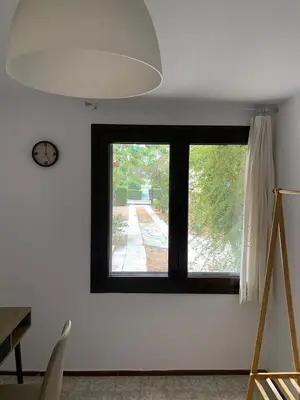 a black window in a white room with a clock at Glyfada Charm, Cozy & Warm with private parking in Athens