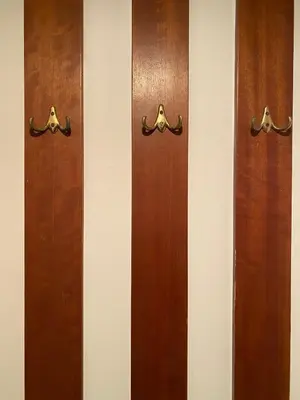 a row of wooden doors on a wall at Glyfada Charm, Cozy & Warm with private parking in Athens