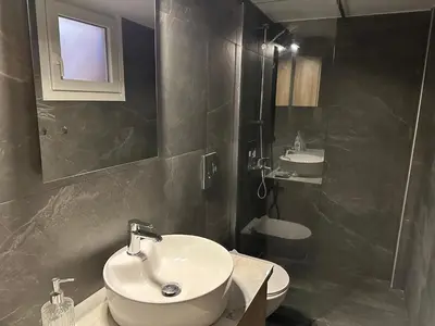 a bathroom with a sink and a toilet and a mirror at Διαμέρισμα κοντά στο μετρό - Flat next to metro in Piraeus