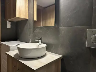a bathroom with a white sink on a counter at Διαμέρισμα κοντά στο μετρό - Flat next to metro in Piraeus