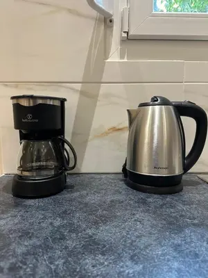 a coffee maker and a tea kettle on a counter at Διαμέρισμα κοντά στο μετρό - Flat next to metro in Piraeus