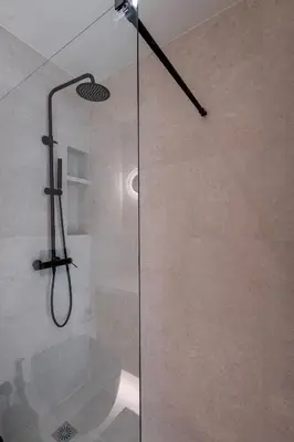 a shower with a glass door in a bathroom at The Portside Getaway - 2BR, 2BA Duplex in Piraeus in Piraeus