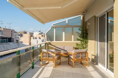 a balcony with two chairs and a table at The Portside Getaway - 2BR, 2BA Duplex in Piraeus in Piraeus