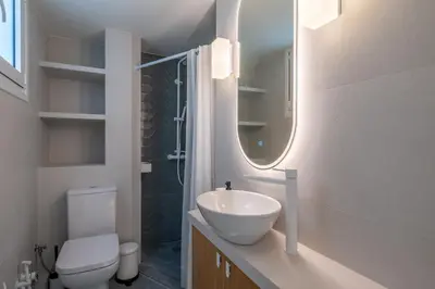 a bathroom with a sink and a toilet and a mirror at The Portside Getaway - 2BR, 2BA Duplex in Piraeus in Piraeus