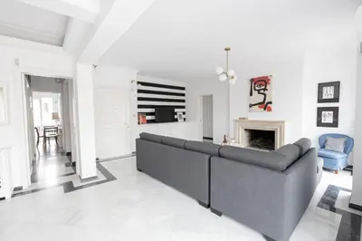 a living room with a couch and a fireplace at Massive 2 Apartment Combo Unbeatable Acropolis Views Sleeps 9 in Athens