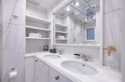 a white bathroom with two sinks and a mirror at Massive 2 Apartment Combo Unbeatable Acropolis Views Sleeps 9 in Athens