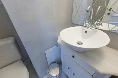 a bathroom with a white sink and a toilet at Massive 2 Apartment Combo Unbeatable Acropolis Views Sleeps 9 in Athens