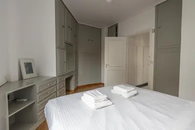 a bedroom with a white bed with towels on it at Massive 2 Apartment Combo Unbeatable Acropolis Views Sleeps 9 in Athens