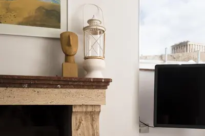 a fireplace with a candle on top of it at Massive 2 Apartment Combo Unbeatable Acropolis Views Sleeps 9 in Athens