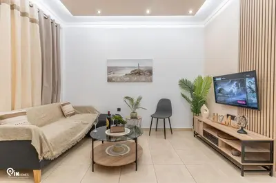 a living room with a couch and a tv at Danae's - Luxury & Modern Apartment in Egaleo-Athens in Athens